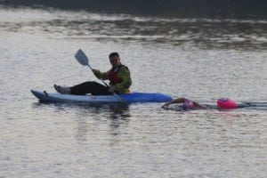 Wendy swimming with kayaker